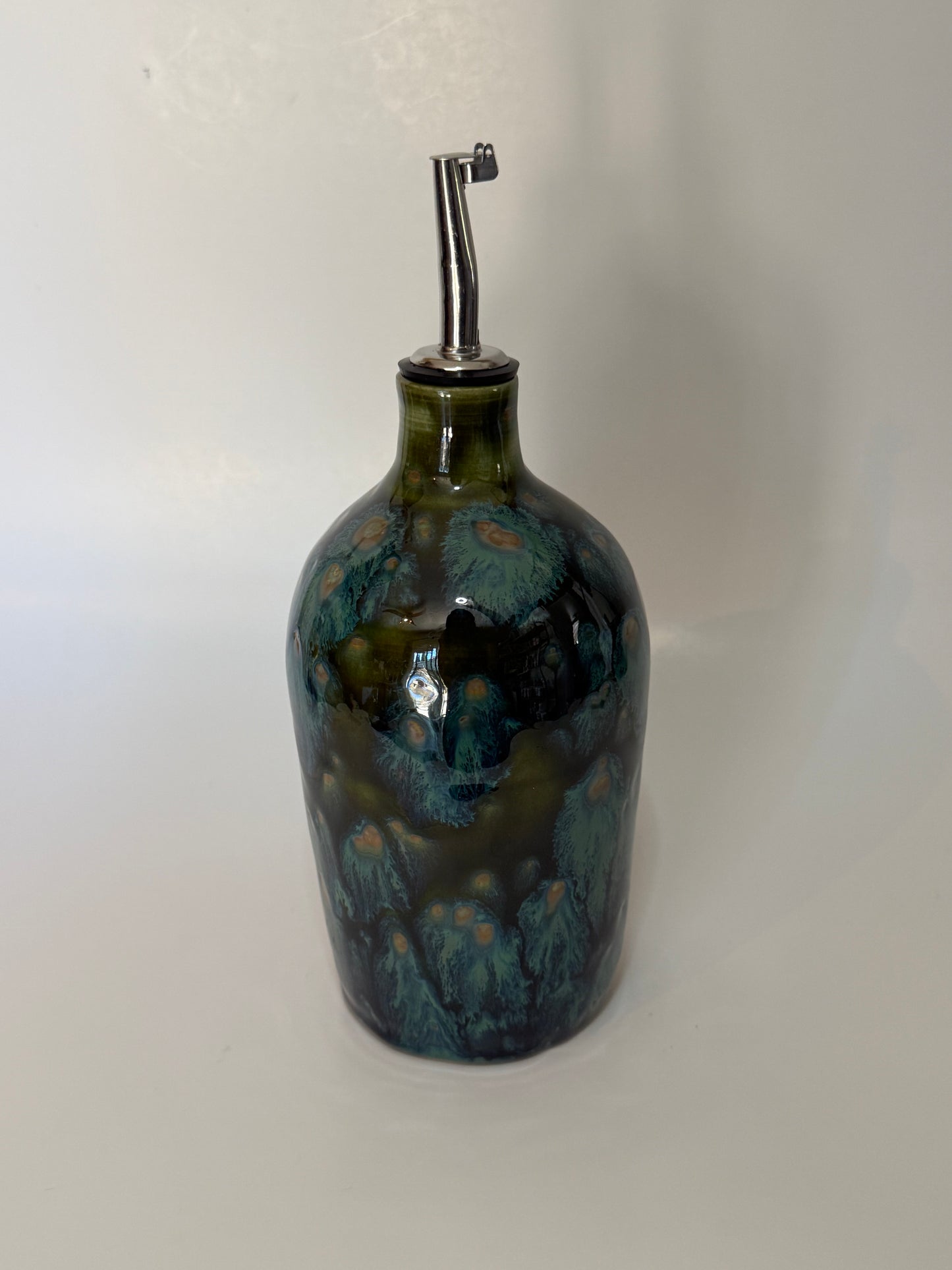 Green speckled oil bottle with sliver oil pour nozzle
