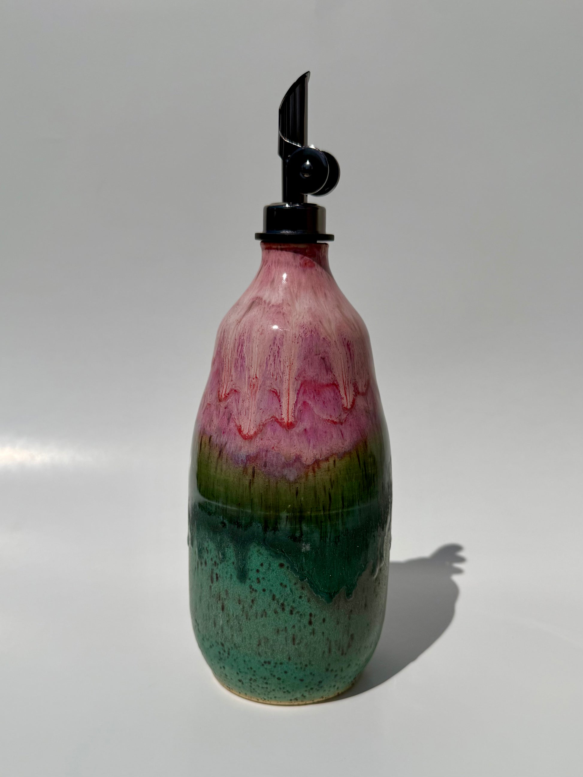Decorative bottle with a multicolored design on a white background