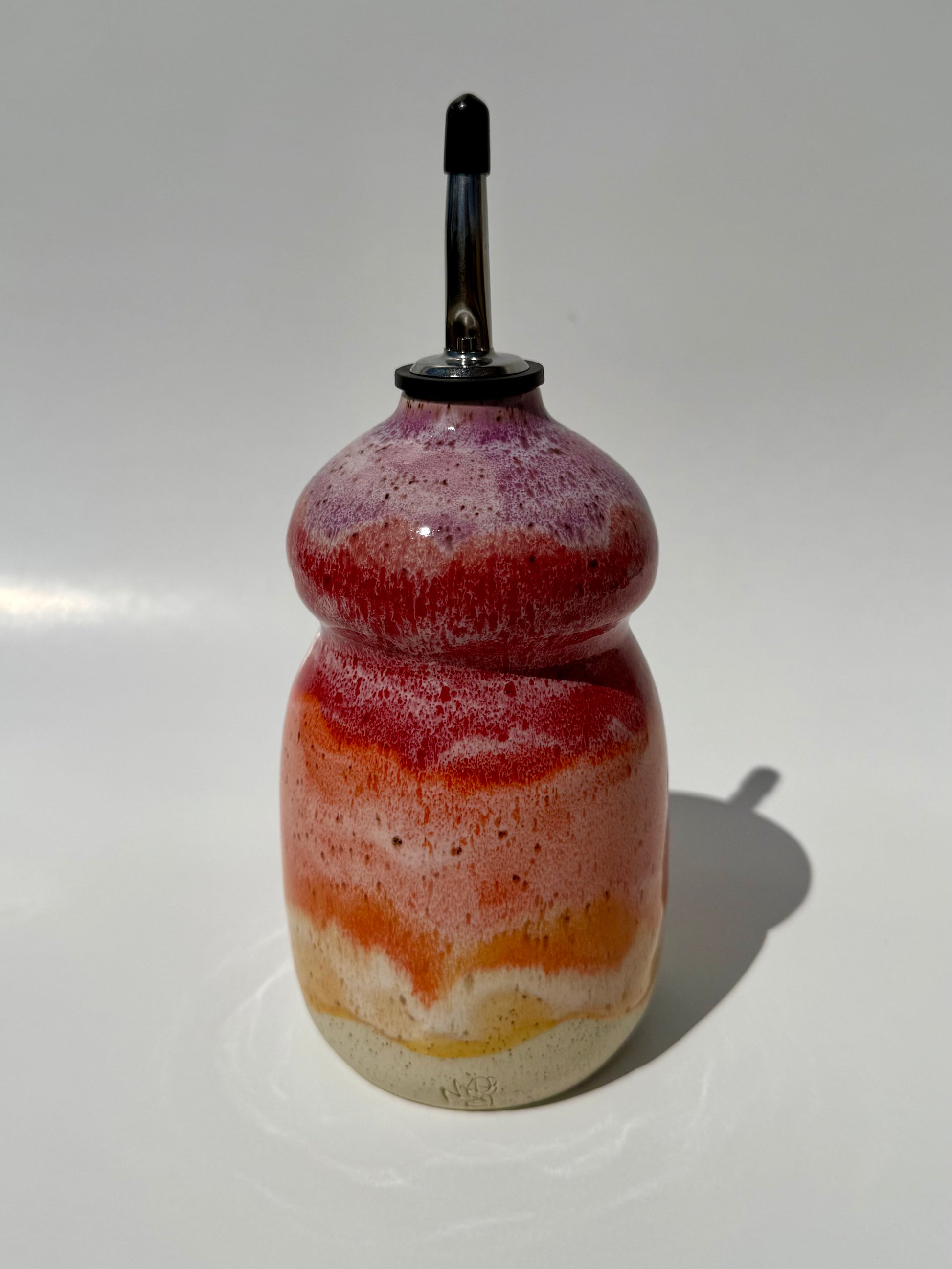 Decorative bottle with multicolored layers on a white background